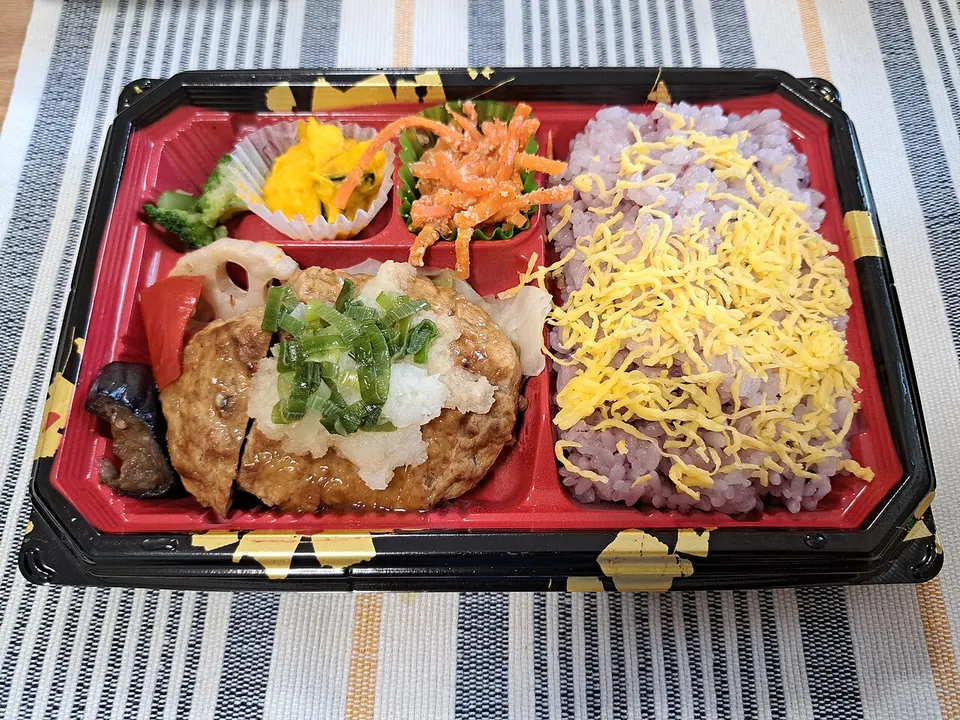 Packaged supermarket bento with hamburger steak and vegetables