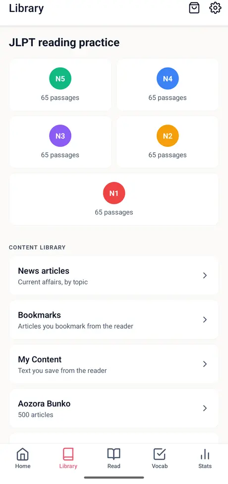 YoMoo Library with JLPT reading practice tiles for N5 to N1, 65 passages each, and the content library list